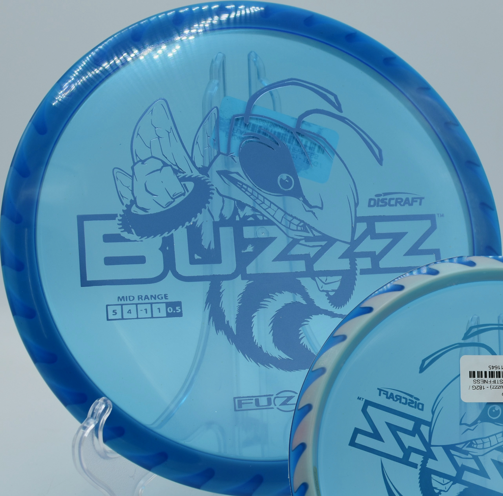 Discraft’s Fuzed Buzzzsaw carving a line around tight woods at Bear’s Den DGC in North Canton, Ohio, designed for confident overstable control.

