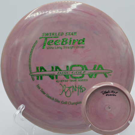 Innova 10X KJ Nybo TeeBird nestled in pine needles at DeLaveaga Disc Golf Course in Santa Cruz, California, highlighting its elite glide and torque-resistant flight.

