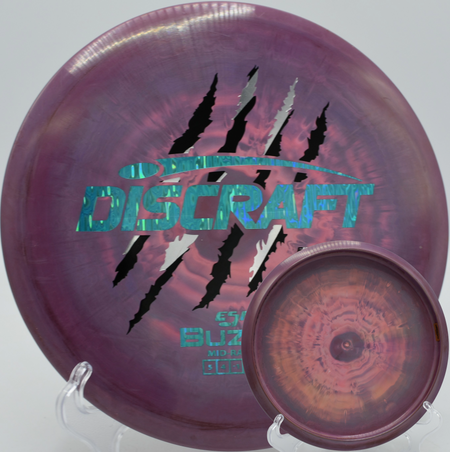 Discraft Buzzz 4 Claw edition placed gently under the basket at Pier Park in Portland, Oregon.