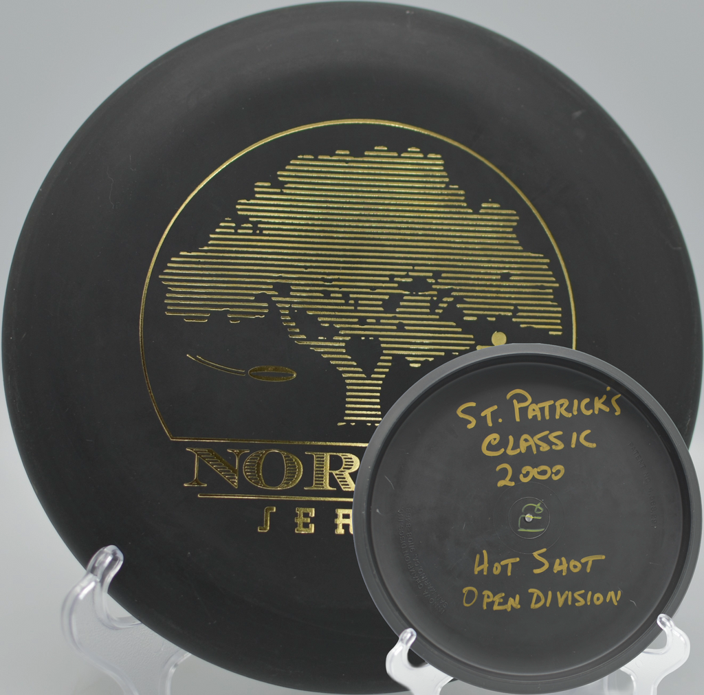 Black 2-Ring San Marino Microbead Aviar w/Pat# (NorCal Series 97–02) gliding across the fairway at Penn Valley Disc Golf Course in Penn Valley, California.