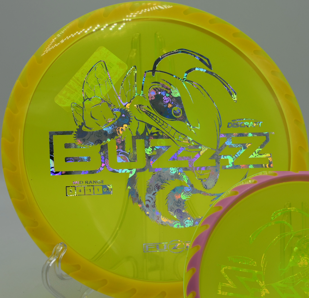 Discraft Fuzed Buzzzsaw placed on the fairway at Rollin Ridge Disc Golf Course in Reedsville, Wisconsin, offering sharp fade and powerful line-holding.

