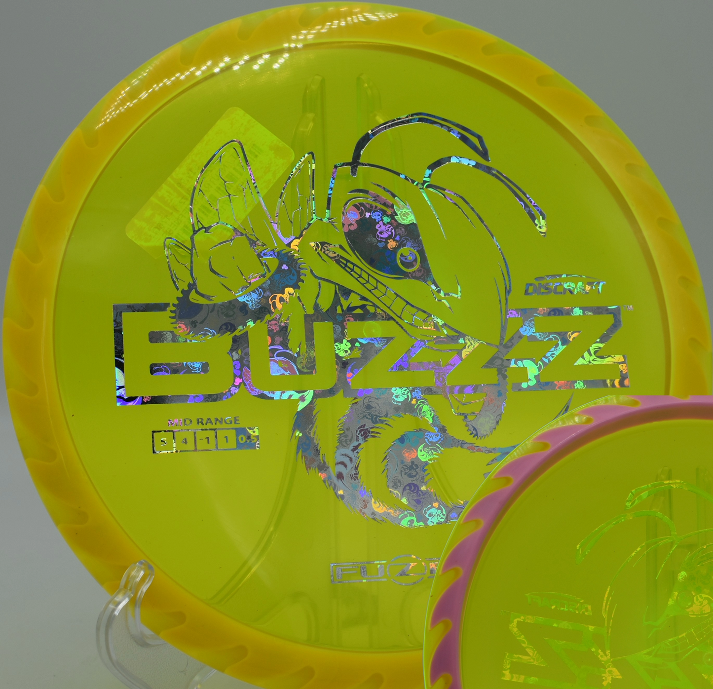 Discraft Fuzed Buzzzsaw placed on the fairway at Rollin Ridge Disc Golf Course in Reedsville, Wisconsin, offering sharp fade and powerful line-holding.

