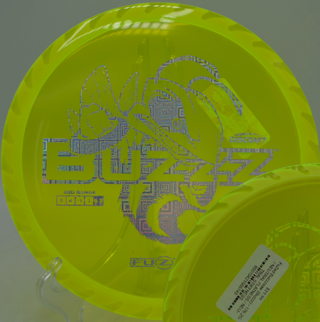 Player shaping a tight tunnel shot with the Fuzed Buzzzsaw at Fox Run Meadows Disc Golf Course in Jeffersonville, Vermont.