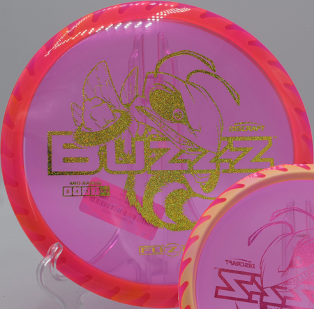 Fuzed Buzzzsaw disc golf midrange spinning through a tunnel shot at Idlewild Disc Golf Course in Burlington, Kentucky, built for torque resistance and powerful fades.

