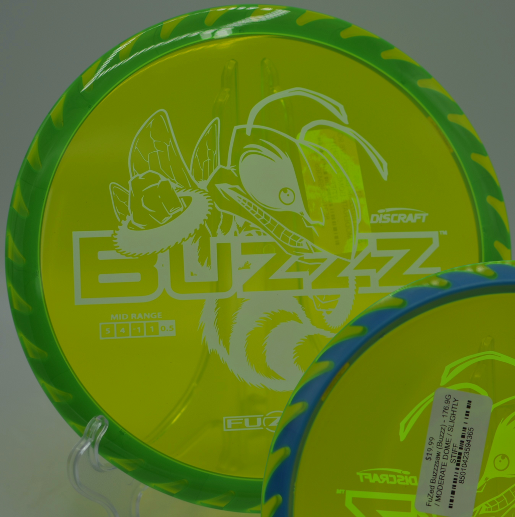 Player aiming a Discraft Fuzed Buzzzsaw midrange through pine-lined fairways at Reedy Creek Disc Golf Course in Charlotte, North Carolina.