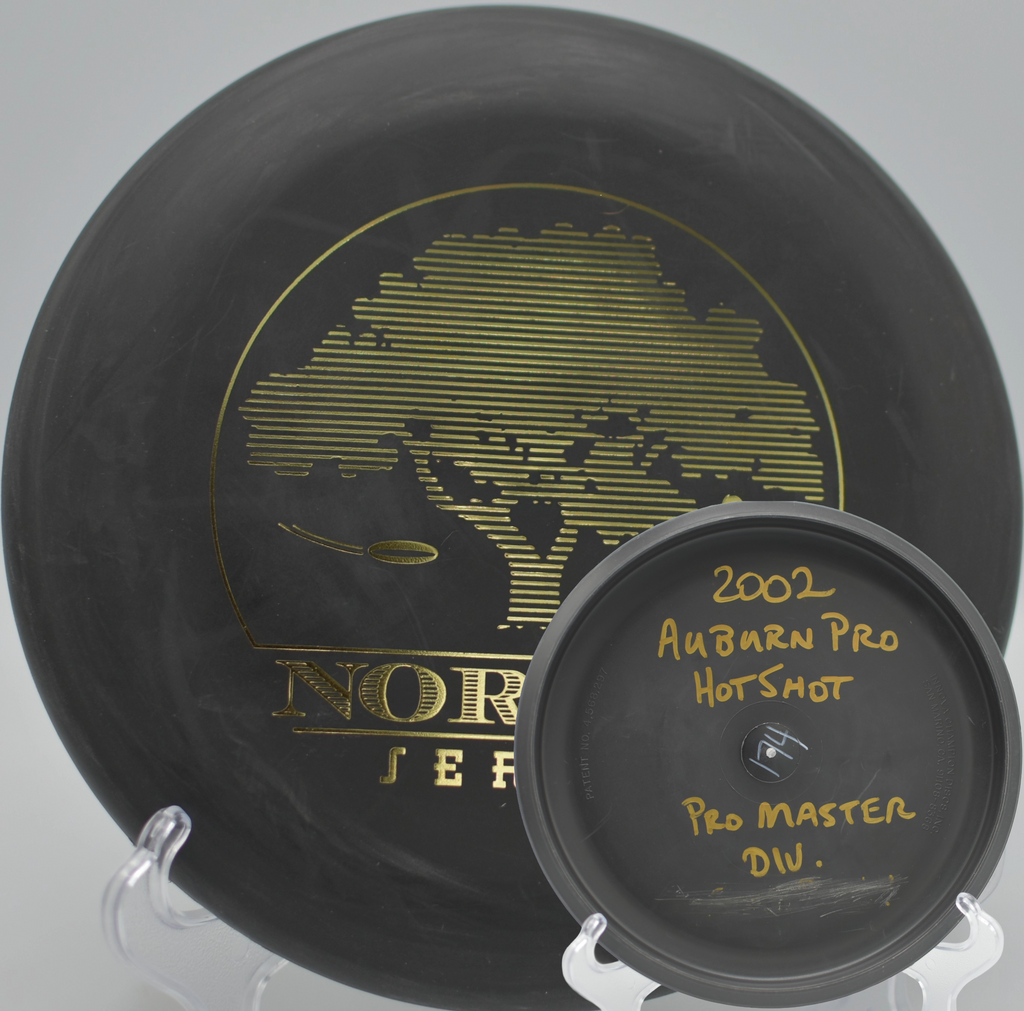 Black 2-Ring San Marino Microbead Aviar w/Pat# (NorCal Series 97–02) resting near the pole after a clean spin putt at Truckee Regional Park Disc Golf Course in Truckee, California.