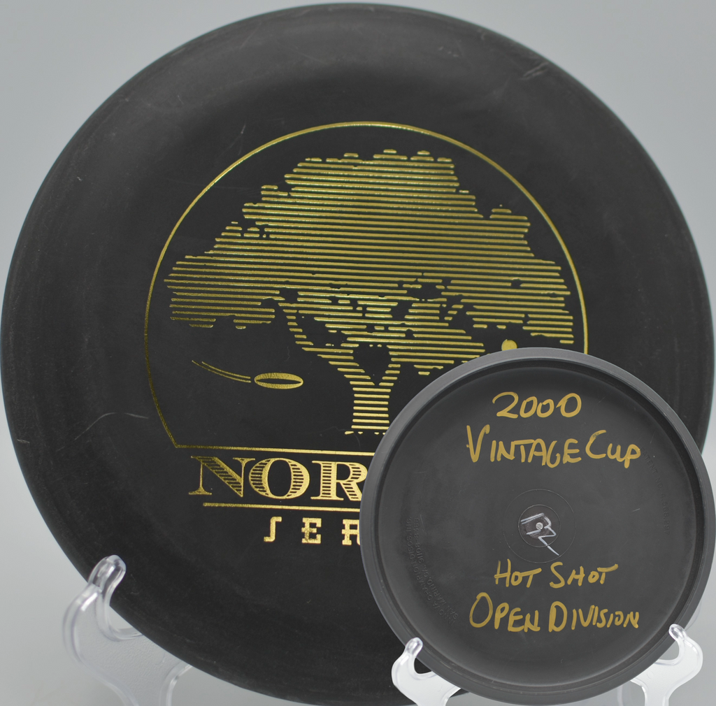 Black 2-Ring San Marino Microbead Aviar w/Pat# (NorCal Series 97–02) parked under the basket at Coyote Point Disc Golf Course in Lakeport, California.