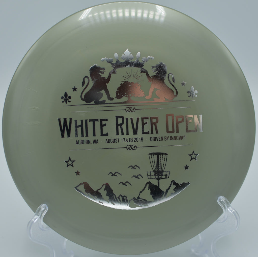 A disc golfer shaping a controlled hyzer with a Star Teebird at Blue Ribbon Pines Disc Golf Course in East Bethel, Minnesota.