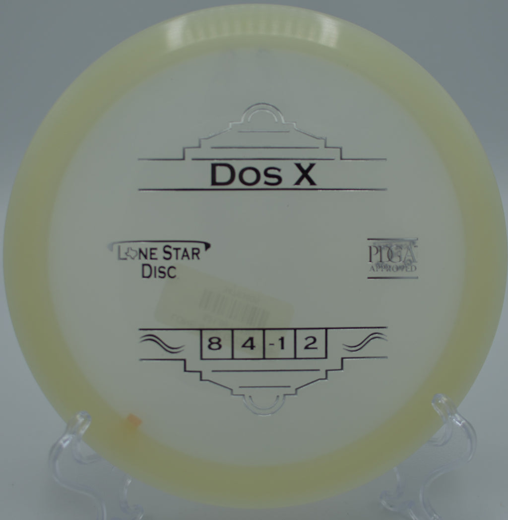 "Lone Star Dos X disc flying over the scenic terrain at Mossy Roc Disc Golf Course in Port Angeles, Washington, highlighting its durability."
