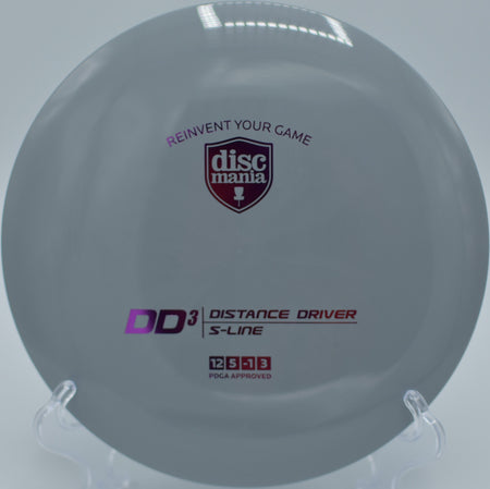 "S-Line DD3 disc golf distance driver in a bold design, captured mid-flight at Fort Steilacoom Disc Golf Course in Lakewood, WA."
